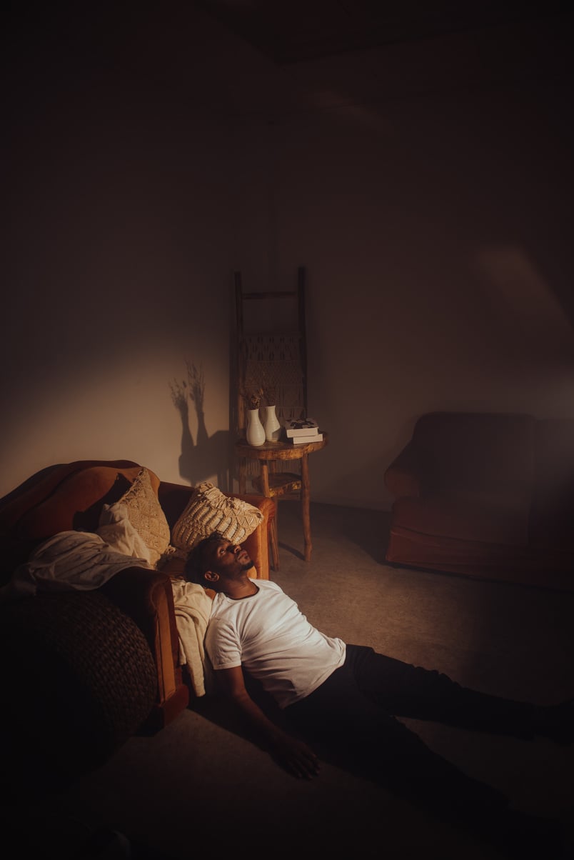 Man Sitting in Room with Light Coming In